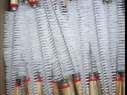 White nylon brushes with red tips packed in a box for bulk supply