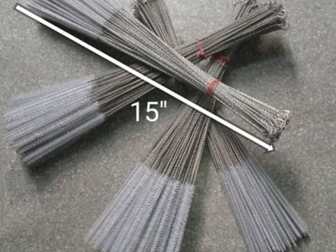 Bundle of white nylon test tube brushes fanned out beside a ruler